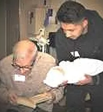 A man and an old man holding white pillows.