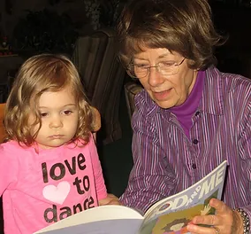 A woman and child reading a book