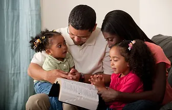 A family reading together on the couch